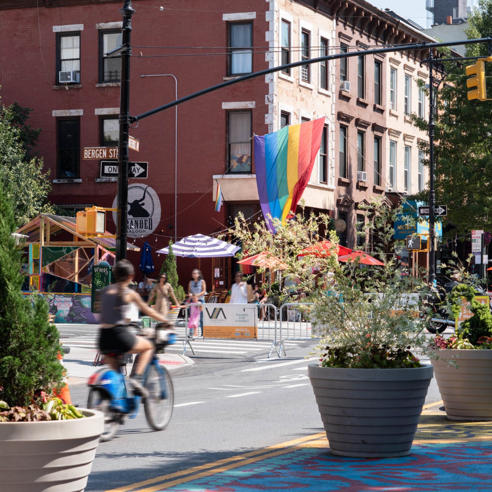 Open streets on Vanderbilt Ave on a sunny day with restaurants and bars in the background
